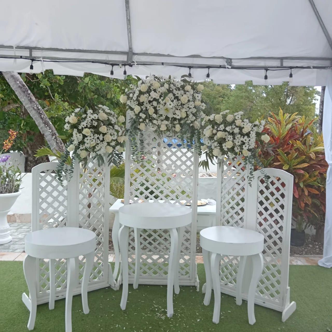 Decoración con paneles celosía y arreglos florales blancos